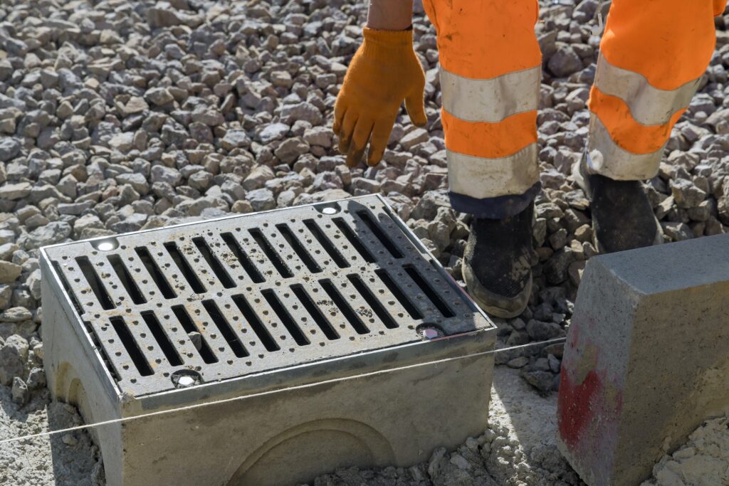Grate on well a concrete base during the laying water drainage construction